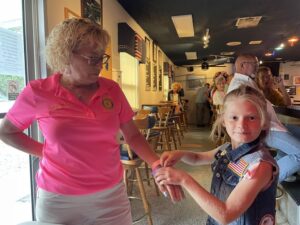 A little help from junior Auxiliary member with the wristbands